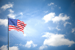 American flag on the blue sky