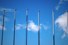 empty flagpoles against sky background